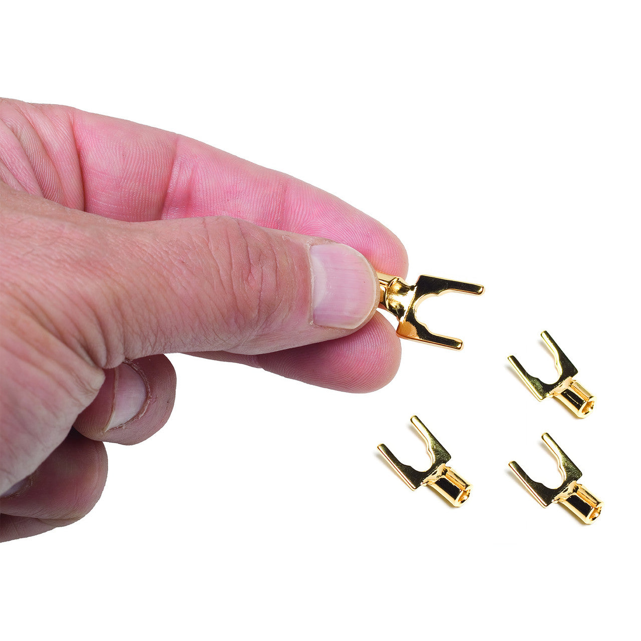 Hand holding a gold spade with more under it